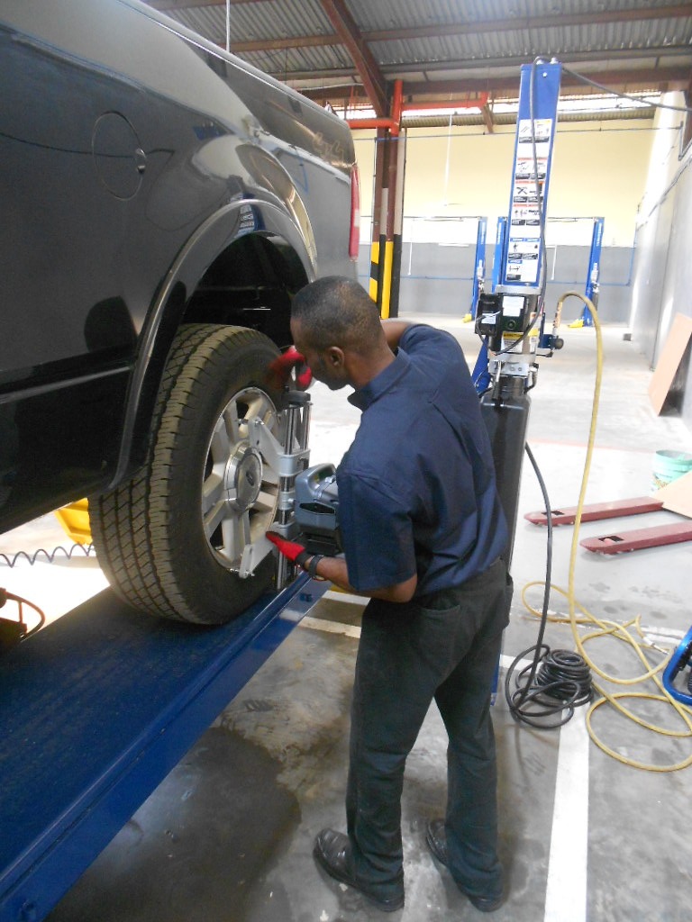Carmax technician carrying out wheel service